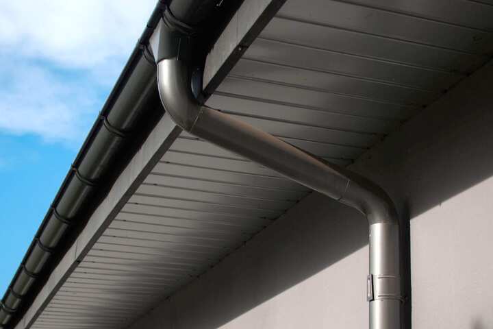 Corrosion-resistant galvanized gutters installed on a commercial building in Tulsa